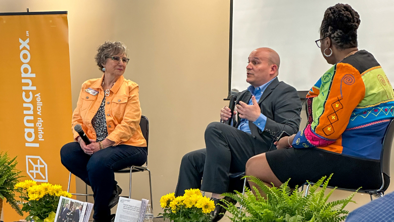 Three people on a stage